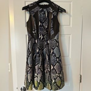 Amazing dress with leather details and snake skin design.